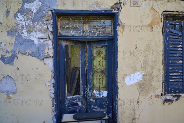 Weathered door and shutters on an old, dilapidated building with peeling paint, Rhodes Old Town, Rhodes Town, Rhodes, Dodecanese, Greek Islands, Greece