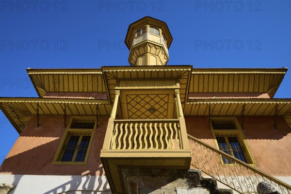 Ottoman building with wood-decorated tower and balconies that stand out majestically against the blue sky, Sokratous Building, Rhodes Old Town, Rhodes Town, Rhodes, Dodecanese, Greek Islands, Greece