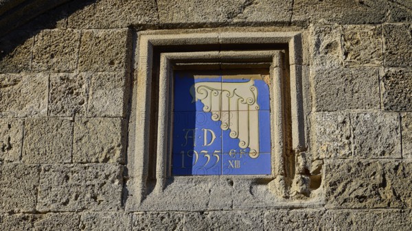 Kasteliani Public Library, Italian coat of arms, Historical façade with a decorative relief and the inscription from 1935 integrated into a stone wall, Rhodes Old Town, Rhodes Town, Rhodes, Dodecanese, Greek Islands, Greece