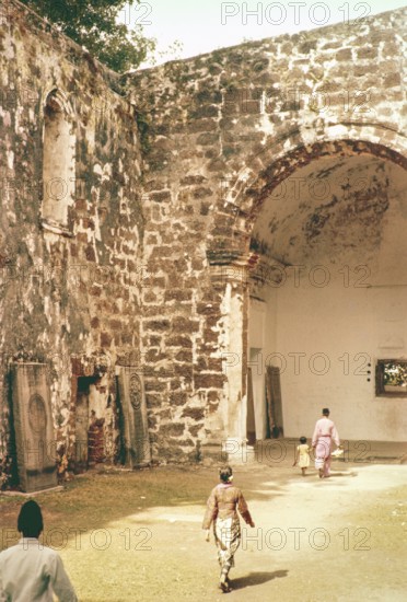 People inside ruined church of Saint Paul Malacca or Melaka, Malaya, Malaysia, south east Asia 1964