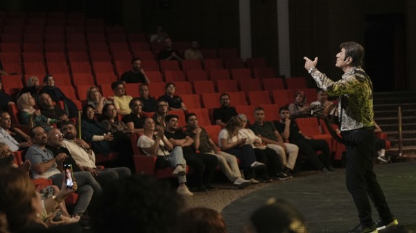 Audience members dance and clap as Turkish singer Coskun Sabah performs during the Türkiye Kültür Yolu Festival, Gaziantep, Gaziantep, Türkiye