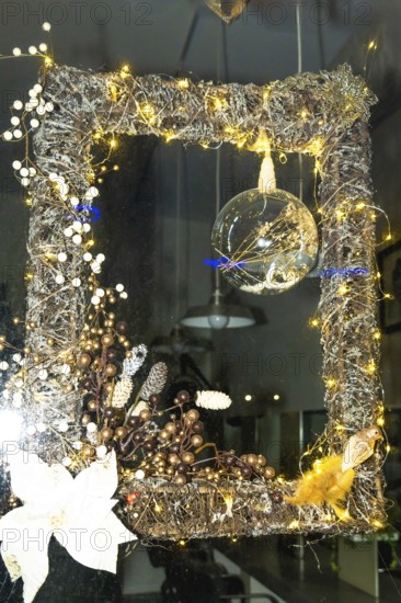 Festive christmas decoration illuminating a shop window in bayonne, france, creating a warm and inviting atmosphere