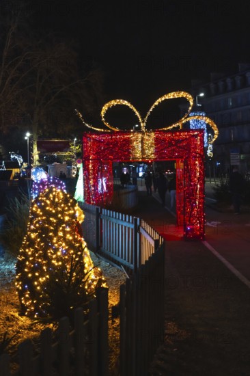 Christmas lights illuminating a giant gift shaped arch during the festive season in bayonne, france, creating a magical atmosphere