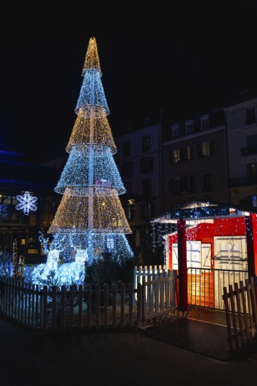 Luminous christmas decorations illuminating bayonne city center at night with reindeer and christmas tree