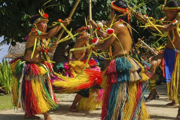Traditional group of dancers from Yap Island dancing in historical traditional costume with headdress performing traditional ritual bamboo dance stick dance with bamboo sticks ritual, Yap Island, Yap State, Caroline Islands, FSM, Federated States of Micronesia, Australia, Oceania