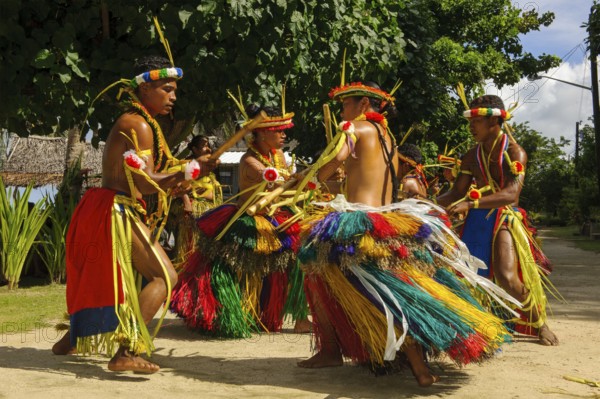 Traditional group of dancers from Yap Island dancing in historical traditional costume with headdress performing traditional ritual bamboo dance stick dance with bamboo sticks ritual, Yap Island, Yap State, Caroline Islands, FSM, Federated States of Micronesia, Australia, Oceania
