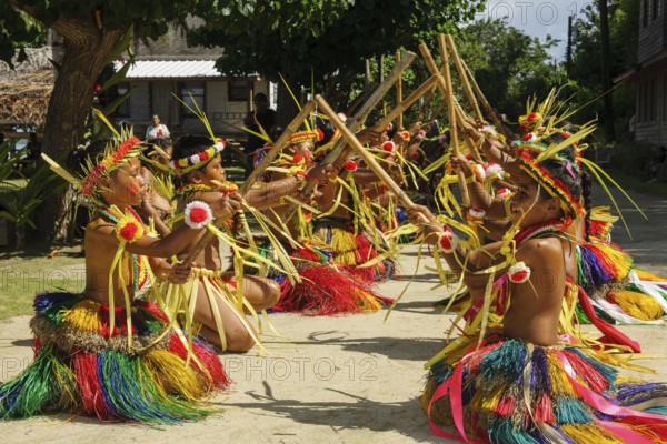 Traditional group of dancers from Yap Island dancing in historical traditional dress traditional costume with free upper body headdress performing traditional ritual bamboo dance stick dance with bamboo sticks, Yap Island, Yap State, Caroline Islands, FSM, Federated States of Micronesia, Australia, Oceania