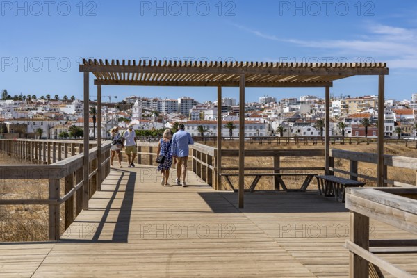 The skyline of the historic centre of Lagos, on the river Bensafrim, view from the boardwalk on the opposite beach Praia de São Roque, in the west of the Algarve, Portugal