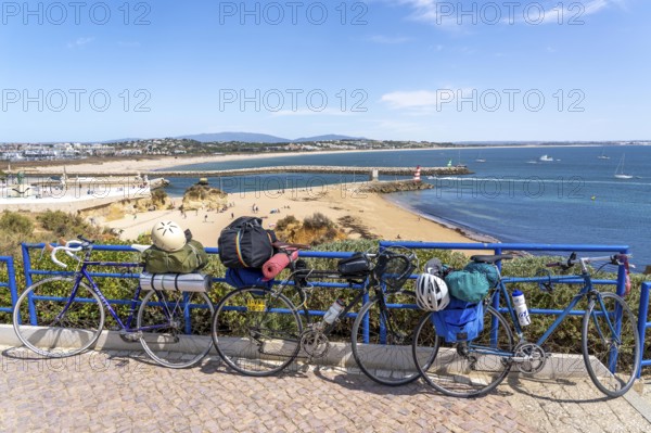 Bicycles with luggage, above the beach Praia da Batata, in the city centre of Lagos, in the west of the Algarve, Portugal