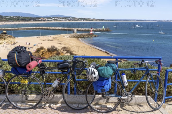 Bicycles with luggage, above the beach Praia da Batata, in the city centre of Lagos, in the west of the Algarve, Portugal