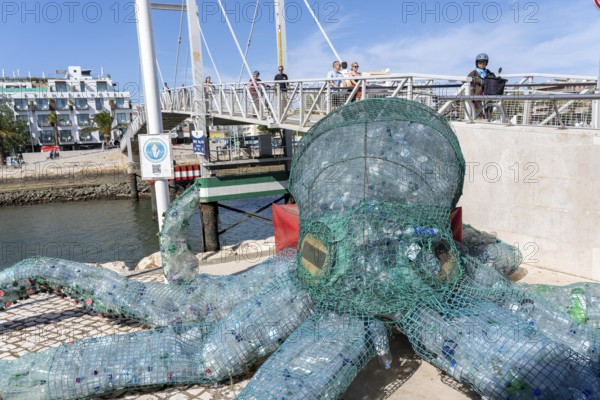 Figure of an octopus, filled with PET bottles, plastic products, reminder not to produce so much plastic waste, in the Marina de Lagos, marina, Lagos, in the west of the Algarve, Portugal