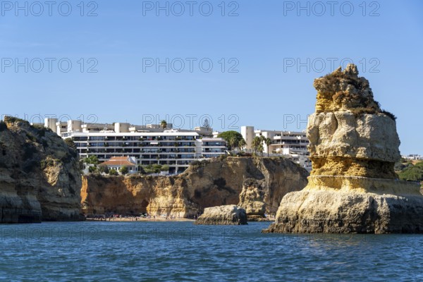 Praia Dona Ana beach, hotel buildings, Ponta da Piedade rocky coast, rugged coastal landscape, right next to the centre of Lagos, in the west of the Algarve, Portugal