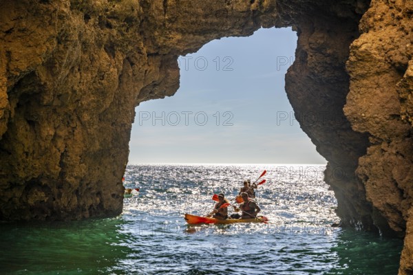 Tour with sea kayaks to the Ponta da Piedade rocky coast, rugged coastal landscape, right next to the city centre of Lagos, in the west of the Algarve, Portugal