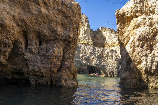 Tour with sea kayaks to the Ponta da Piedade rocky coast, rugged coastal landscape, right next to the city centre of Lagos, in the west of the Algarve, Portugal