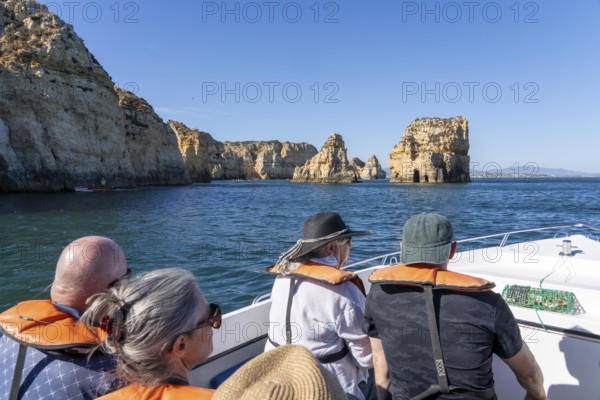 Tour with a small motorboat to the Ponta da Piedade rocky coast, rugged coastal landscape, right next to the city centre of Lagos, in the west of the Algarve, Portugal