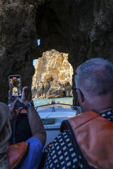Tour with a small motorboat to the Ponta da Piedade rocky coast, rugged coastal landscape, right next to the city centre of Lagos, in the west of the Algarve, Portugal