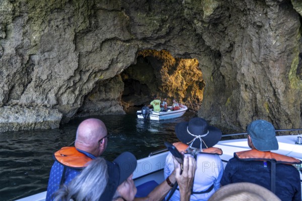 Tour with a small motorboat to the Ponta da Piedade rocky coast, rugged coastal landscape, right next to the city centre of Lagos, in the west of the Algarve, Portugal