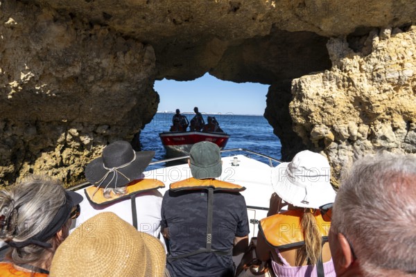 Tour with a small motorboat to the Ponta da Piedade rocky coast, rugged coastal landscape, right next to the city centre of Lagos, in the west of the Algarve, Portugal