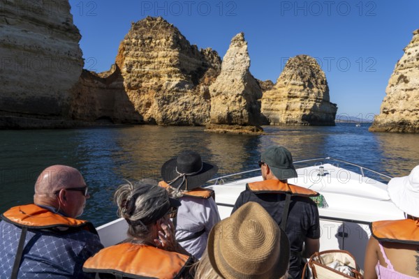 Tour with a small motorboat to the Ponta da Piedade rocky coast, rugged coastal landscape, right next to the city centre of Lagos, in the west of the Algarve, Portugal