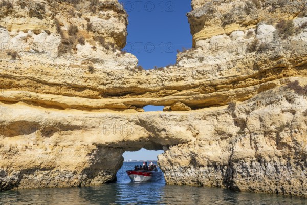 Tour with a small motorboat to the Ponta da Piedade rocky coast, rugged coastal landscape, right next to the city centre of Lagos, in the west of the Algarve, Portugal