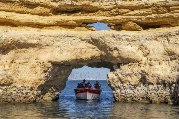 Tour with a small motorboat to the Ponta da Piedade rocky coast, rugged coastal landscape, right next to the city centre of Lagos, in the west of the Algarve, Portugal