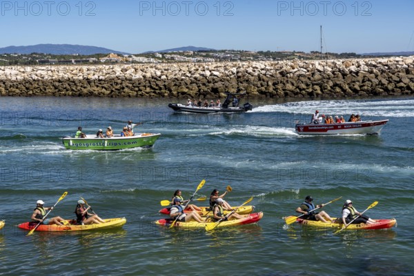 Kayak tours to the rocky coast of Ponta da Piedade, groups of tourists kayak on the sea to the rugged coastline of Lagos, in the west of the Algarve, Portugal