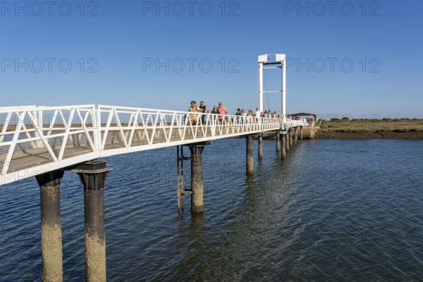 Bridge over the lagoon to the kilometre-long sandy beach Praia do Barril, on the island off Santa Luzia, Algarve, Portugal