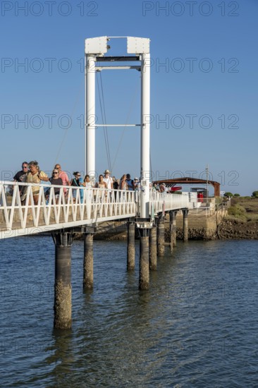 Bridge over the lagoon to the kilometre-long sandy beach Praia do Barril, on the island off Santa Luzia, Algarve, Portugal
