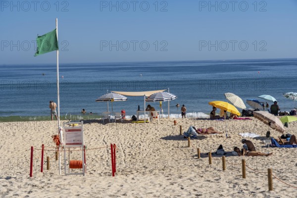 Kilometre-long sandy beach Praia do Barril, on the island off Santa Luzia, green flag indicates swimming permitted, lifeguards on the beach, Algarve, Portugal