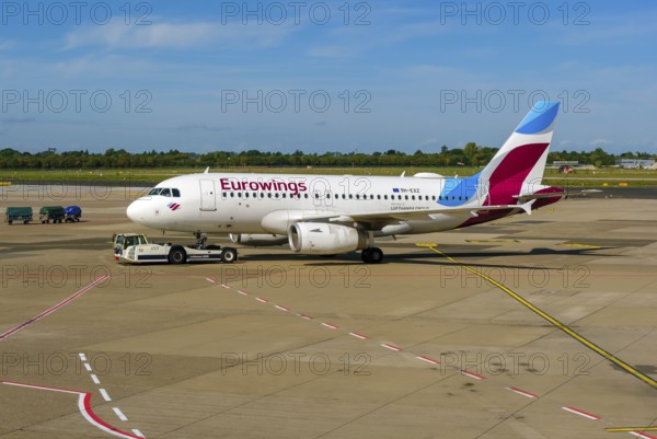 Düsseldorf, North Rhine-Westphalia, Germany - Düsseldorf Airport, Eurowings aircraft being towed by Lufthansa LEO on the apron towards the runway, pushback