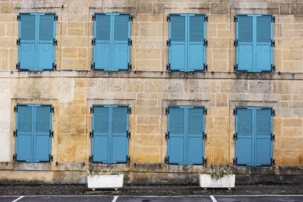Closed, green shutters, historic house facade, yellow sandstone, Marville, Renaissance village, Département Meuse, Grand Est, France