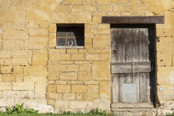 Wooden door, window, historic house facade, yellow sandstone, Marville, Renaissance village, Département Meuse, Grand Est, France