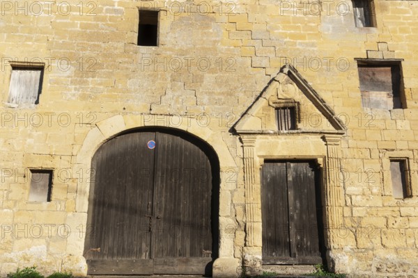 Wooden door, window, historic house facade, yellow sandstone, Marville, Renaissance village, Département Meuse, Grand Est, France