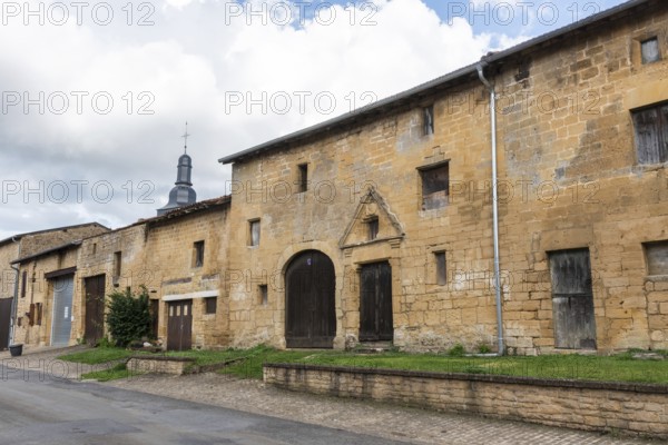 Abandoned street with historic house facades, yellow sandstone, Marville, Renaissance village, Département Meuse, Grand Est, France