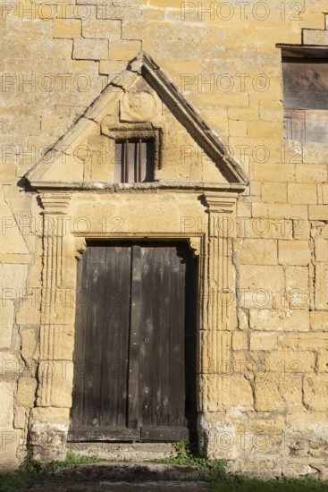 Wooden door, historic house façade, yellow sandstone, Marville, Renaissance village, Département Meuse, Grand Est, France