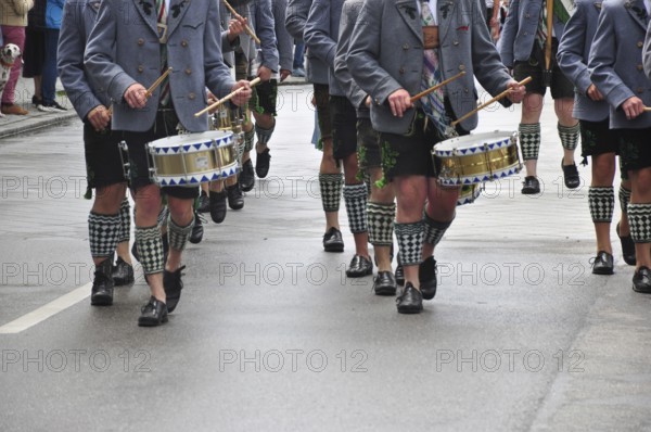 Men in traditional traditional costume play drums during a traditional Bavarian parade, Gaujugendfestzug