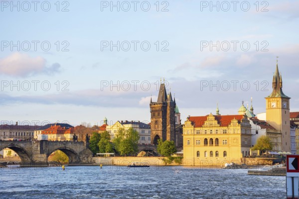 View of old town with Charles Bridge (Karluv Most) on Vltava river and Old Town Bridge Tower, famous tourist destination in Prague, Czech Republic (Czechia), at sunset