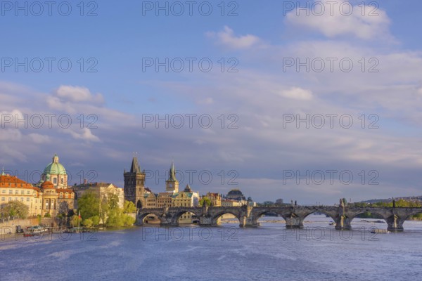 Charles Bridge (Karluv Most) on Vltava river and Old Town Bridge Tower, famous tourist destination in Prague, Czech Republic (Czechia), at sunset