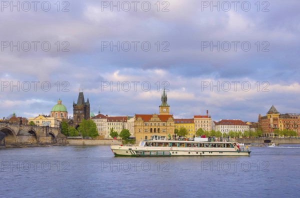 View of old town with Charles Bridge (Karluv Most) on Vltava river and Old Town Bridge Tower, famous tourist destination in Prague, Czech Republic (Czechia), at sunset