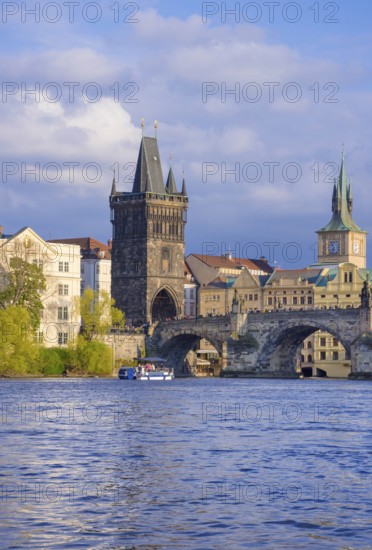 Charles Bridge (Karluv Most) on Vltava river and Old Town Bridge Tower, famous tourist destination in Prague, Czech Republic (Czechia), at sunset
