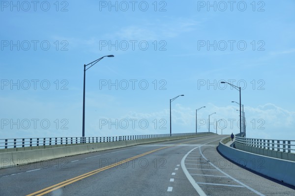 An empty bridge under a clear blue sky conveys a calm and lonely atmosphere, A. Max Brewer Bridge, Titusville, Florida, USA