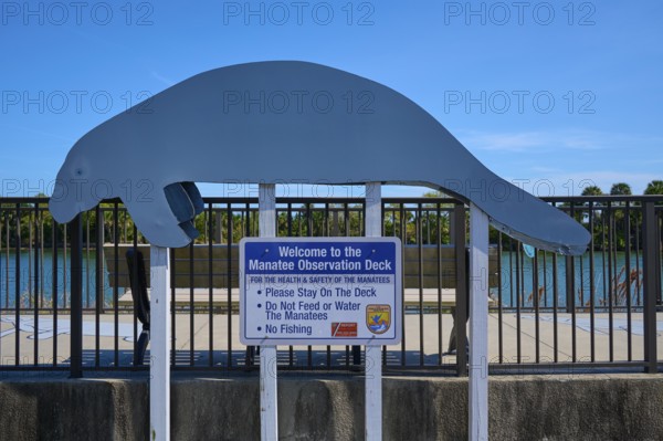 Manatee observation deck with sign under a clear sky, Haulover Canal, Merritt Island National Wildlife Refuge, Mims, Florida, USA