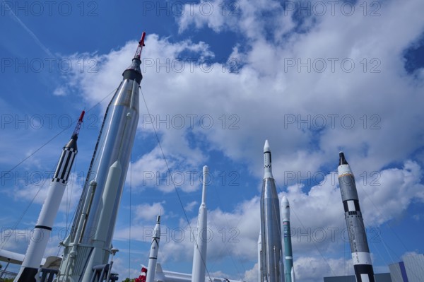 Various rockets rising into the blue sky, surrounded by clouds, Kennedy Space Centre Visitor Complex, Merritt Island, Florida, USA