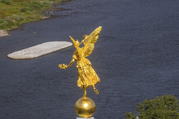Fama (the goddess of rumours) on the dome of the Academy of Fine Arts, with the pillar foundation of the former Carola bridges, Dresden, Saxony, Germany