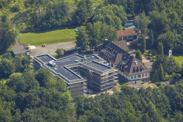 Aerial view, construction site and new building for the children's home Marienfrieden, SkF Hochsauerland Sozialdienst kath. Frauen e.V., Hüsten, Arnsberg, Sauerland, North Rhine-Westphalia, Germany, construction work, construction area, building site, building plots, construction project, construction site, DE, Europe, Haus Marienfrieden, Hochsauerlandkreis, children's home, aerial photograph, aerial photography, aerial photography, new building, photovoltaics, photovoltaic system, SkF Hochsauerland, solar, solar system, solar energy, solar energy, overview, bird's-eye view, birds-eyes view, overview
