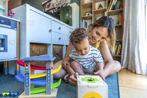 Happy mother and son enjoying playtime together, engaging with colorful educational toys in the comfort of their living room