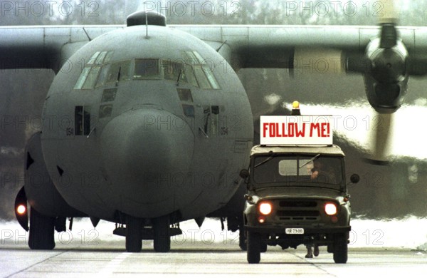 HUN, Karposvar, 01.12.1995 -- An American military aircraft is guided by a Hungarian military jeep at the airfield near Karposvar. -- A U.S. C-30 military cargo plane is led by a Hungarian military jeep apon it s arrival at the airbase in Karposvar. Eastern Europe
