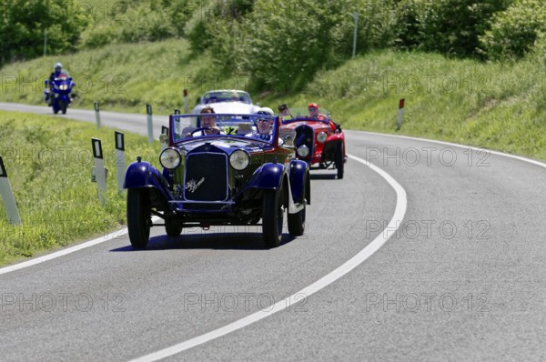 A blue and a red classic car driving one behind the other on a road, classic car, car race, Mille Miglia, 1000 Miglia, 2015, Tuscany, Rome Lake Garda, Italy