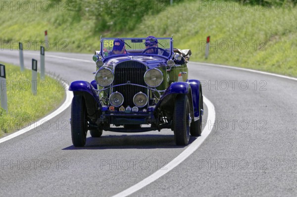 Dark blue classic car on a winding road under a bright sun, classic car, car race, Mille Miglia, 1000 Miglia, 2015, Tuscany, Rome Lake Garda, Italy