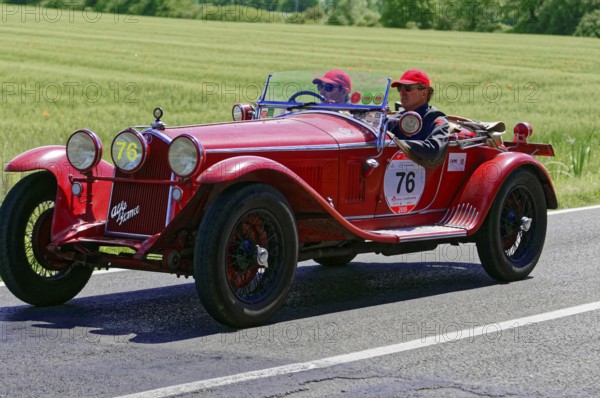 A classic red vintage car with two drivers on a country road, vintage car, car race, Mille Miglia, 1000 Miglia, 2015, Tuscany, Rome Lake Garda, Italy